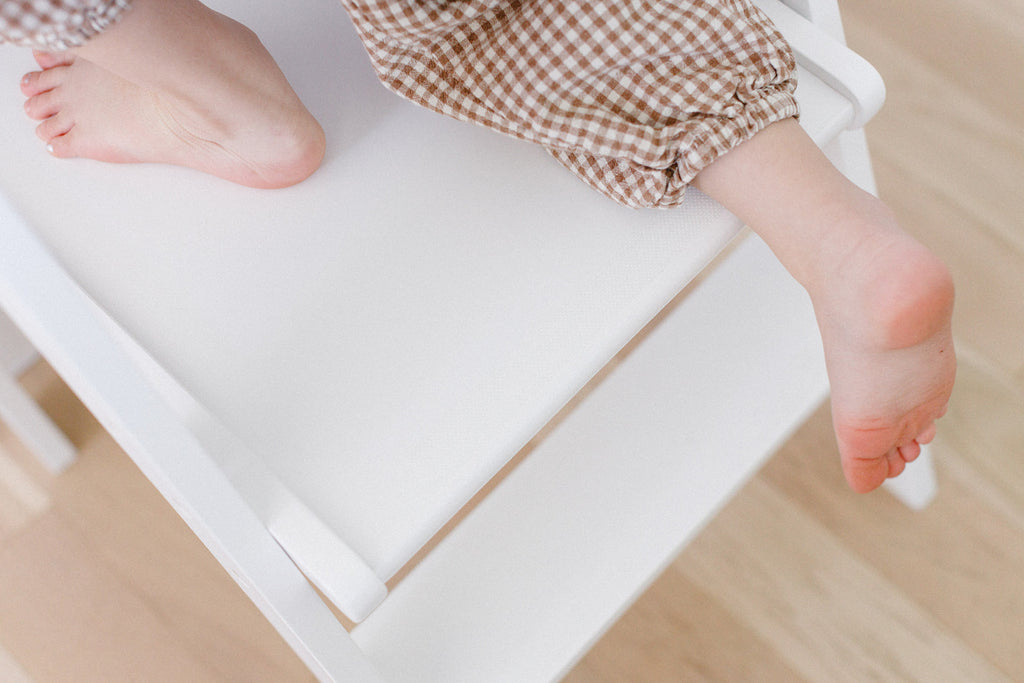 detailed photo of kids feet climbing on a learning tower