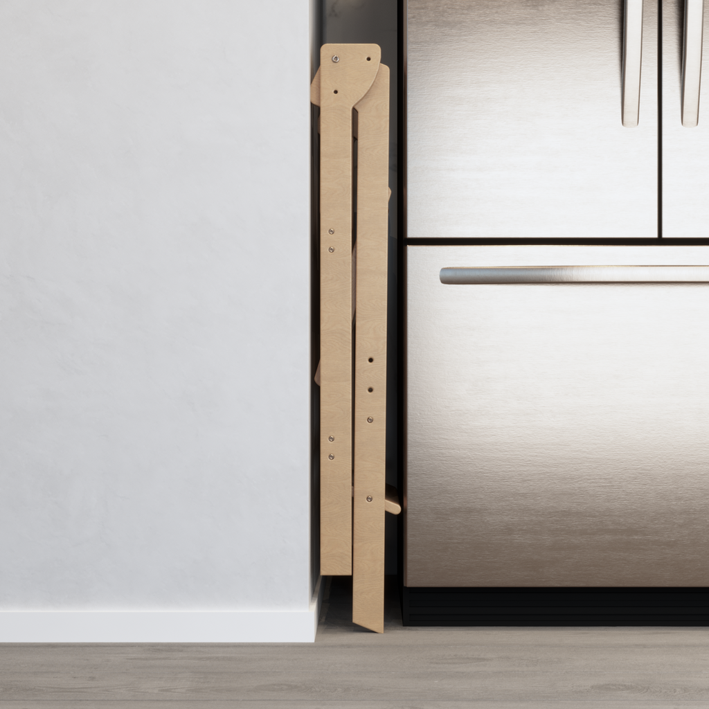A double wide learning tower that is tucked away for storage in the 6 inch gap between a fridge and wall. 