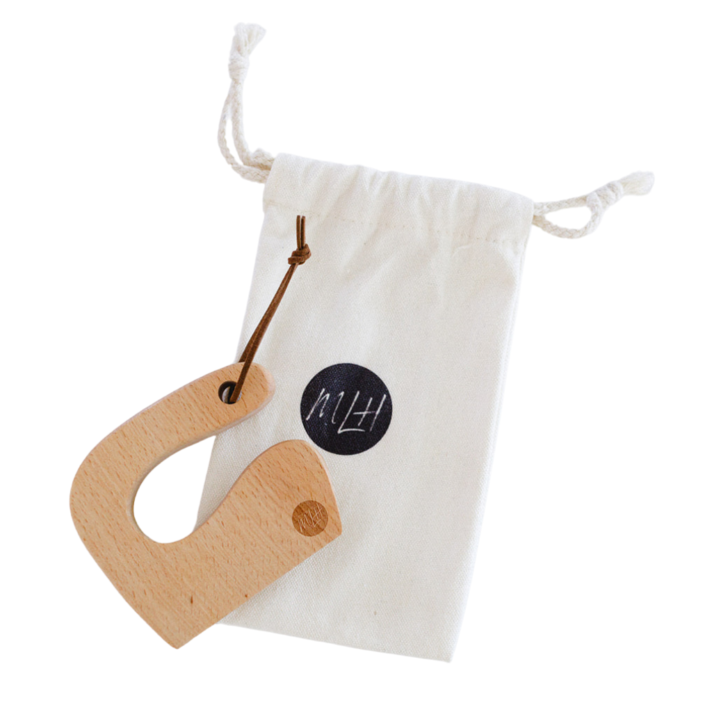 Wooden knife on a white drawstring bag with a visible brand logo.