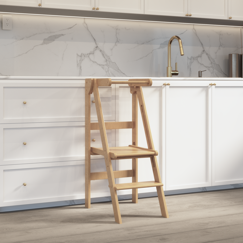 A natural wood learning stool for toddlers pictured in a white kitchen. 