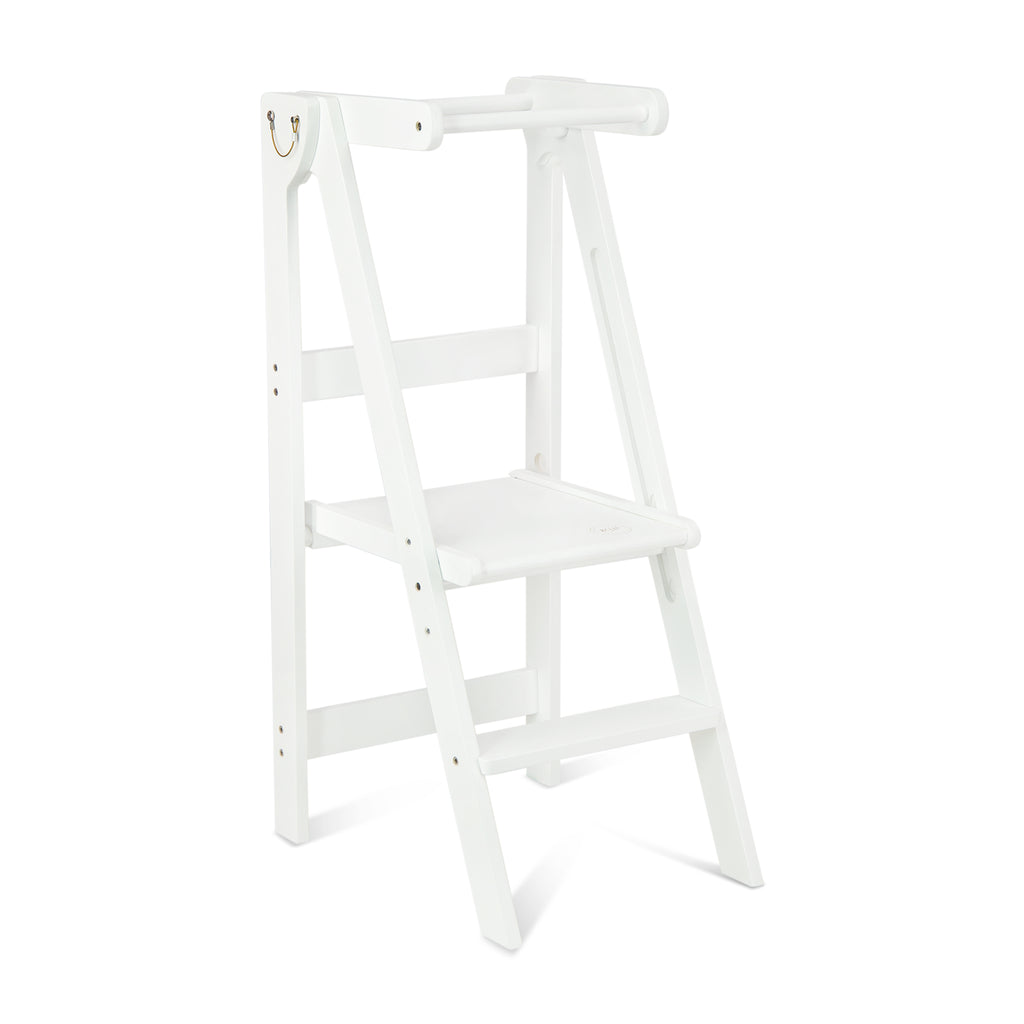 A white wooden folding learning tower set up in the open position with the platform adjusted to the middle height. 