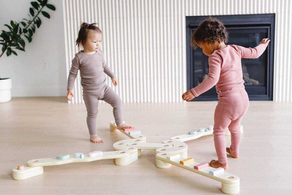 children are playing on the balance beam set