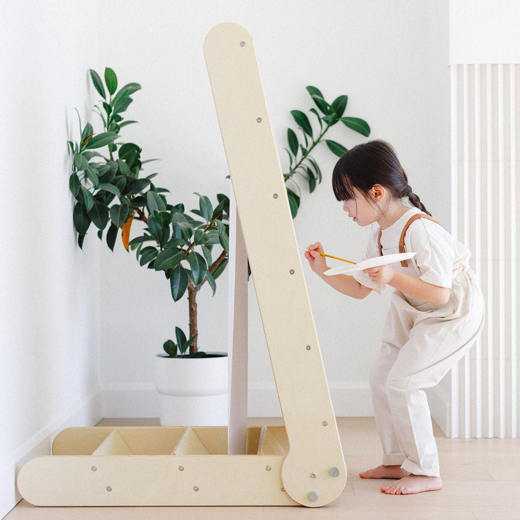 the slide transforms into an easel and a little girl is painting an art