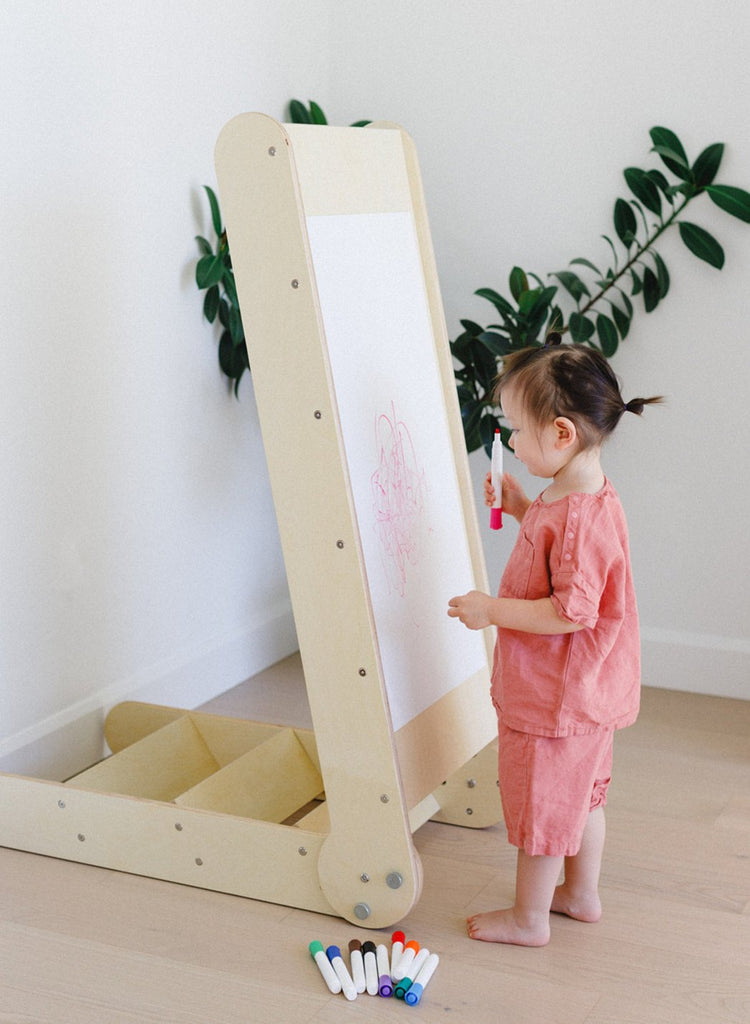 a little girl is happy painting an art