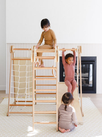 3 kids are enjoying while playing in the indoor play gym