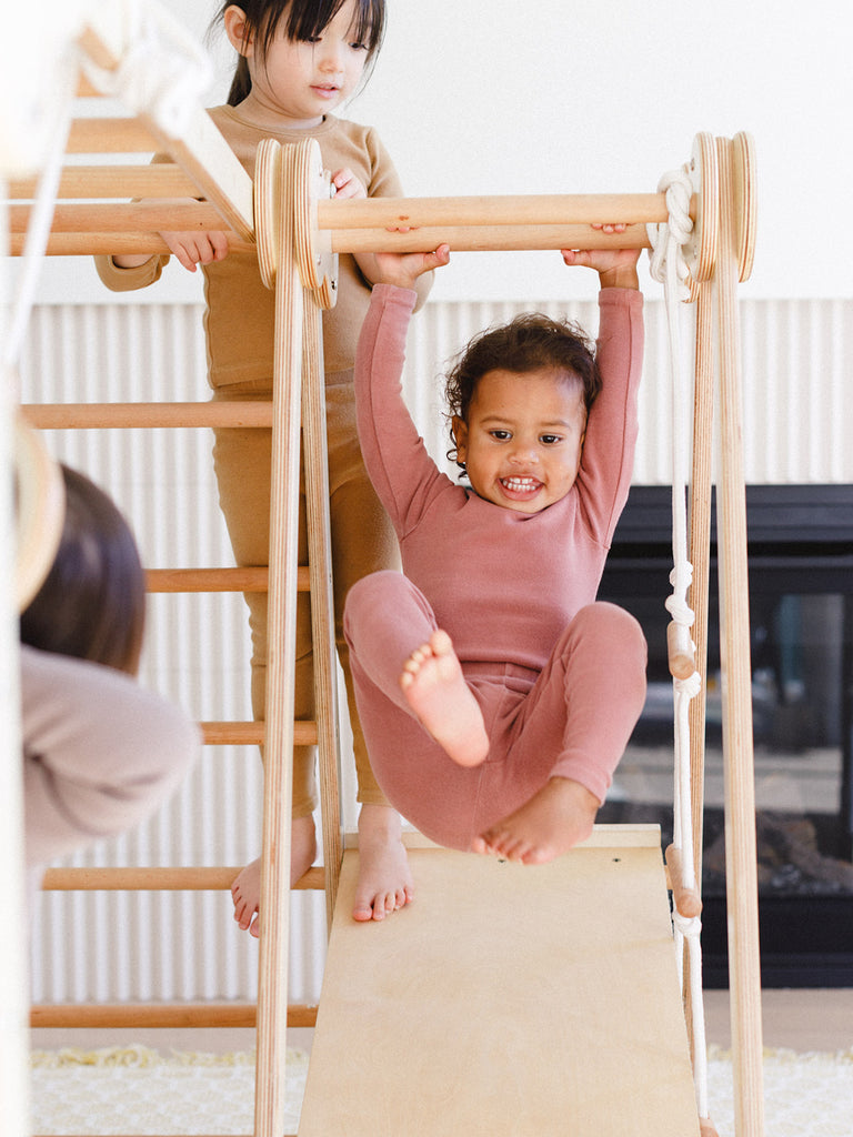 the kids are enjoying while sliding in the indoor play gym