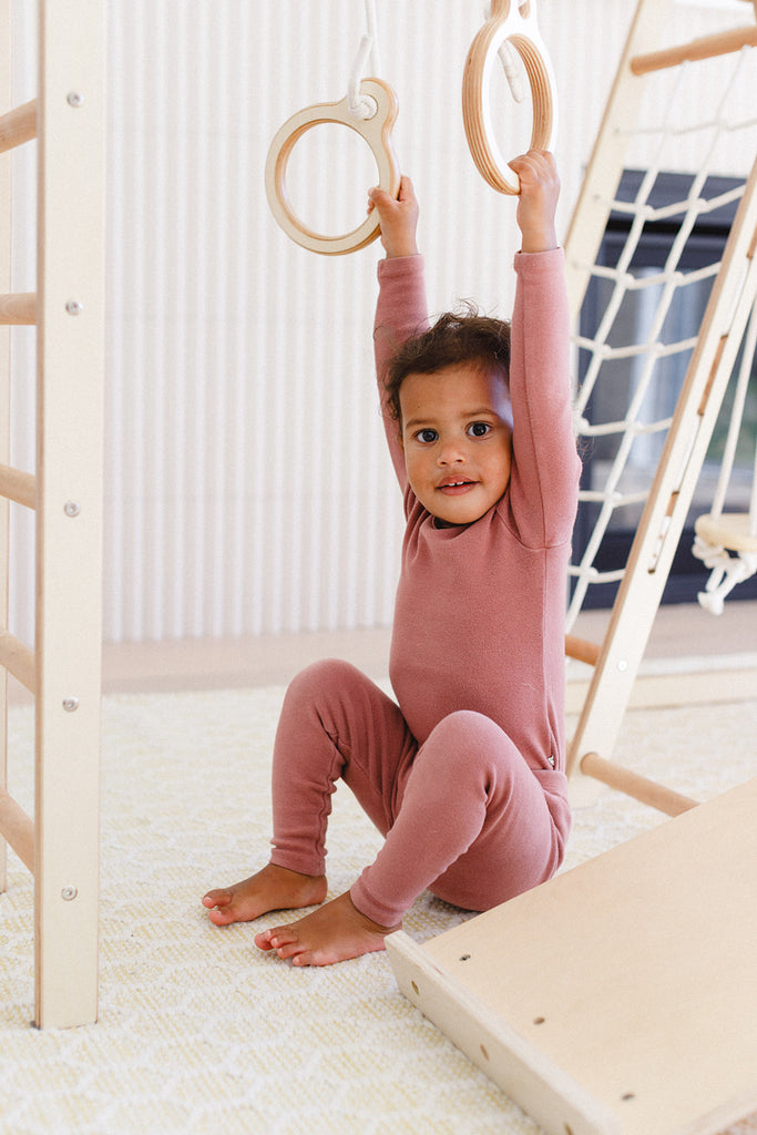 the little girl is holding the ring sets