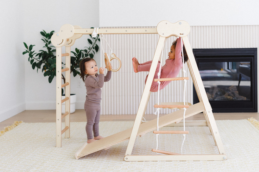 little girls playing in the play gym