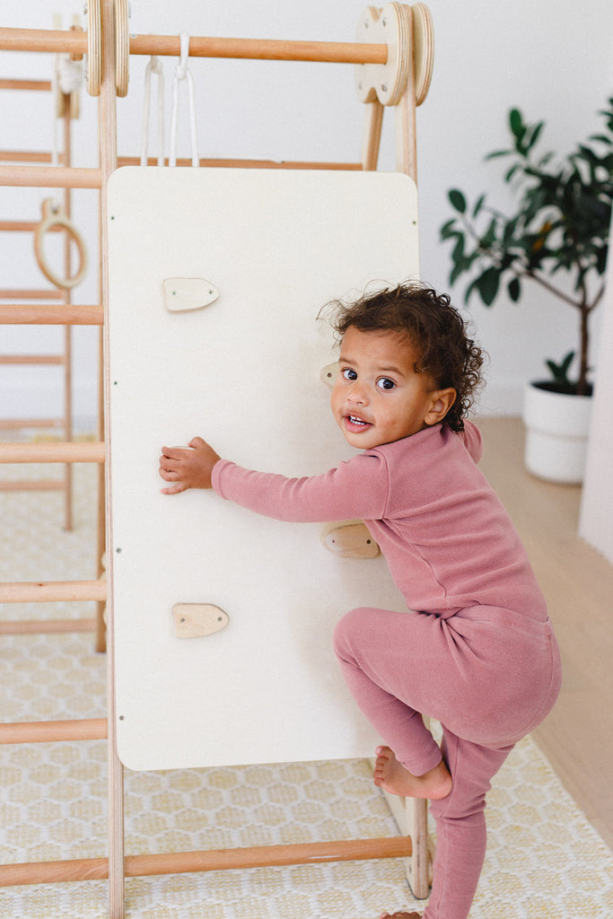 a girl smiling while trying to climb up