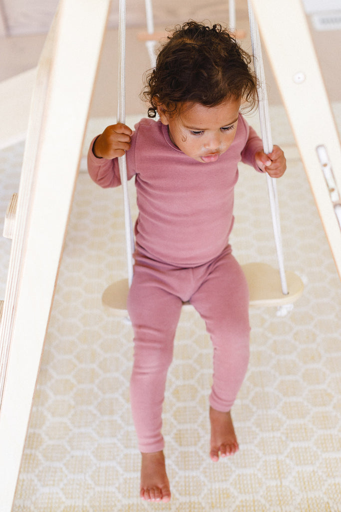 the little girl is swinging