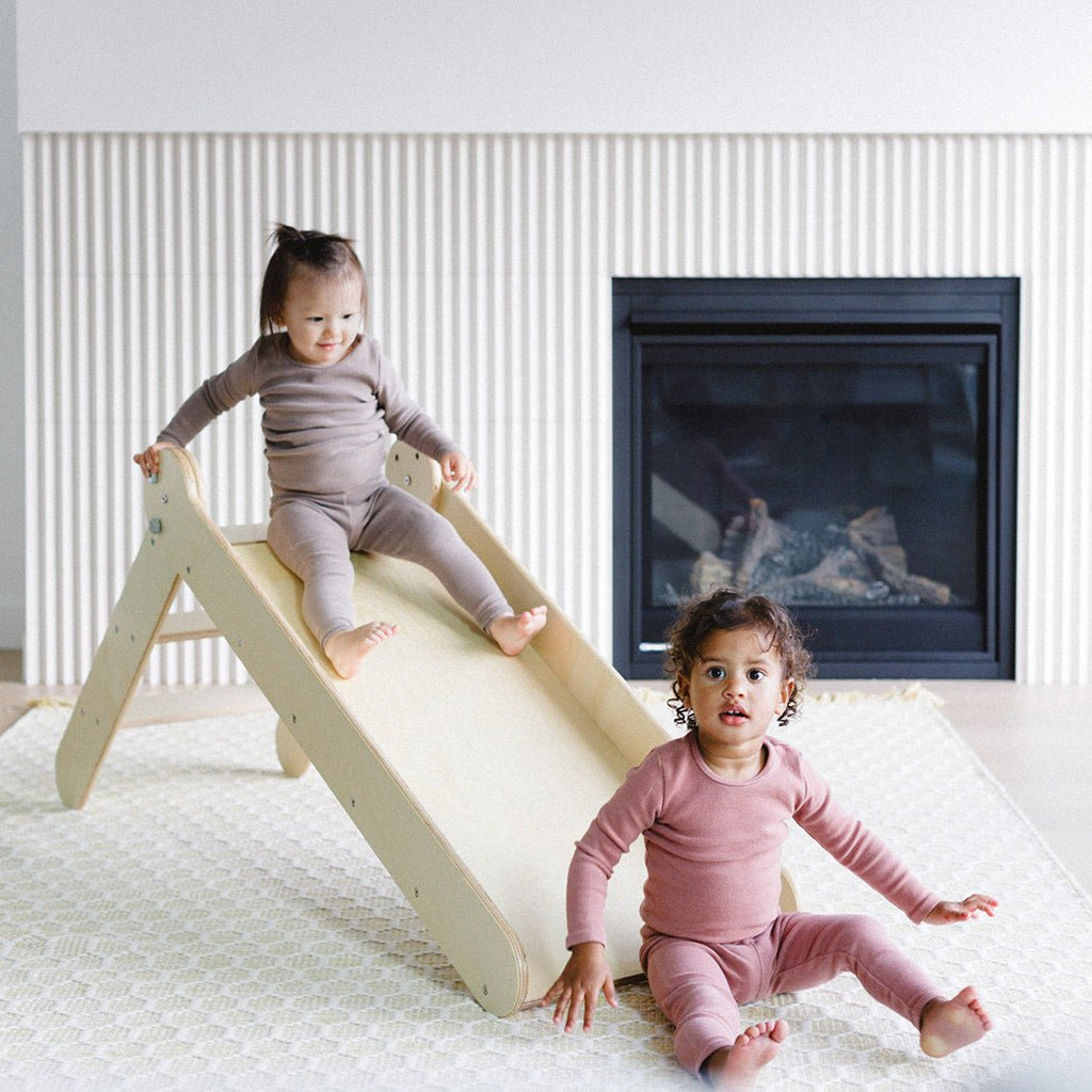 the kids are enjoying taking a slide 