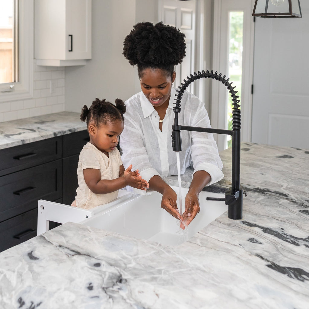 Child and Mother washing hands in sink with toddler standing on white Classic Montessori Learning Tower