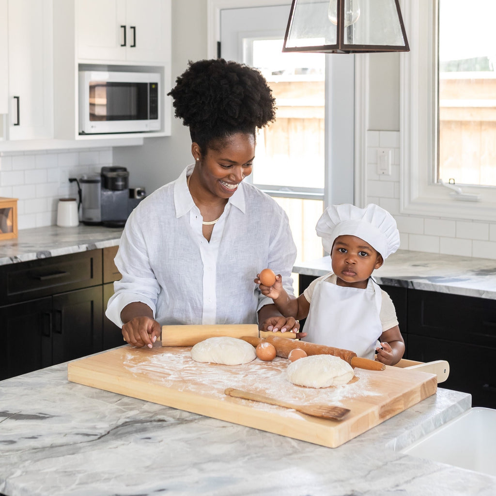 Mother and Child using Montessori Toddler Learning Tower to bake in kitchen - Kitchen helper