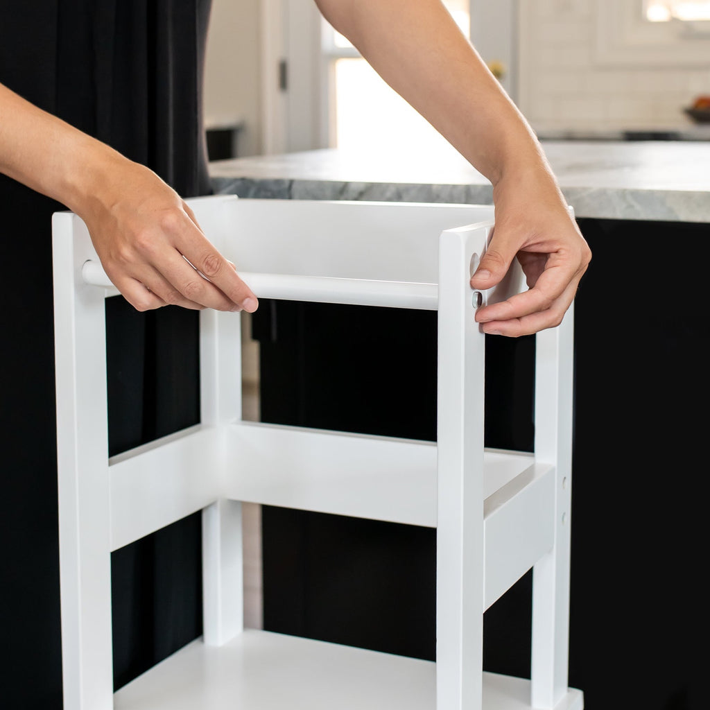 Toddler Classic Montessori Learning Tower, woman easily locking in the safety bar