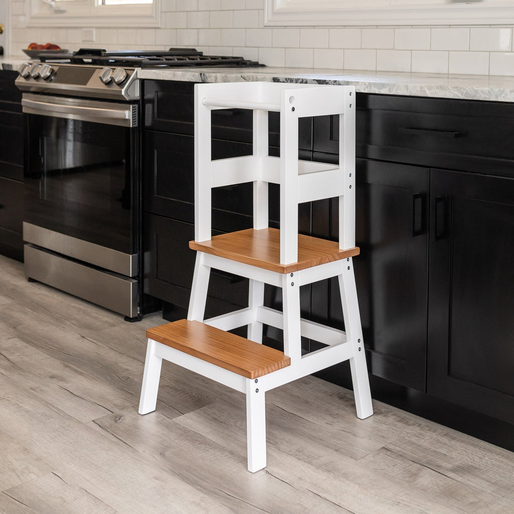Early American and White Color Classic Montessori Toddler Learning Tower stands on display against a Kitchen Counter