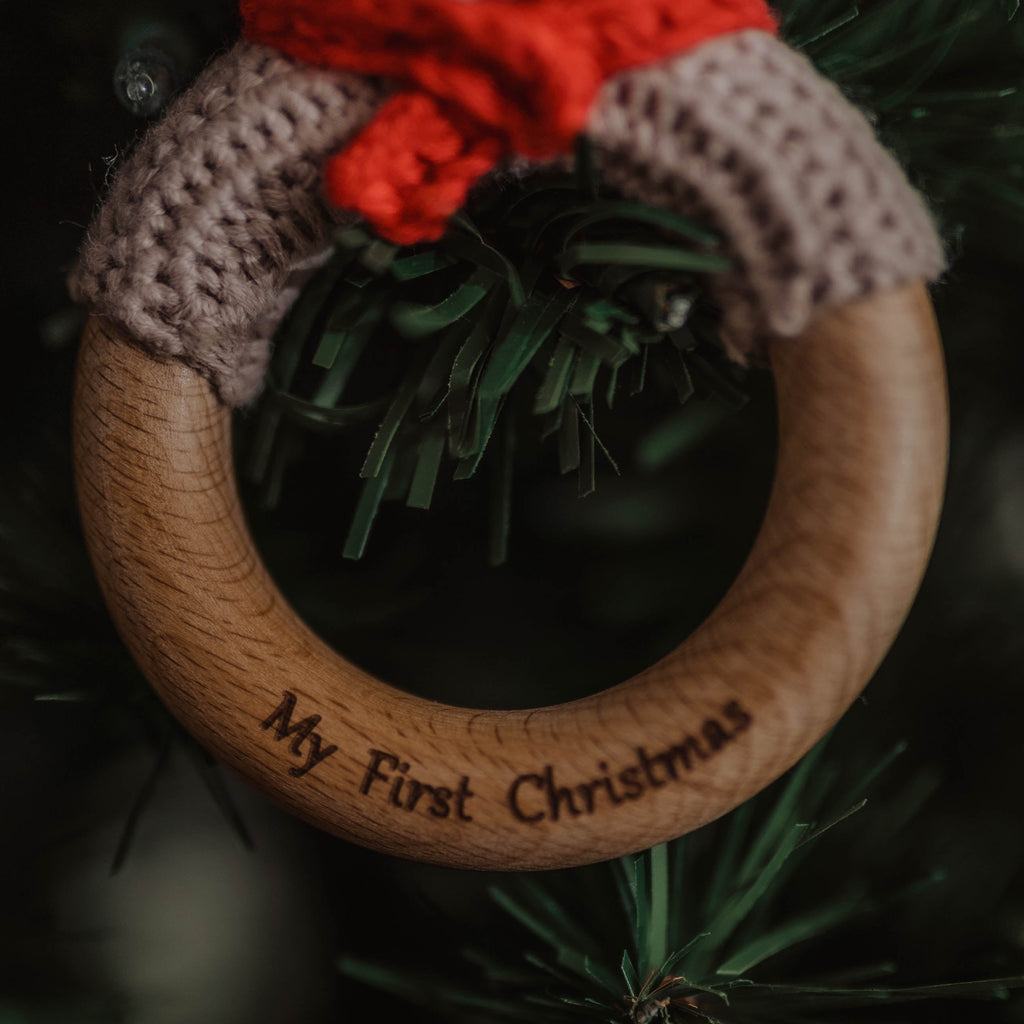 Close up view of "My First Christmas" engraved on wooden handle of Crochet Christmas Rattle