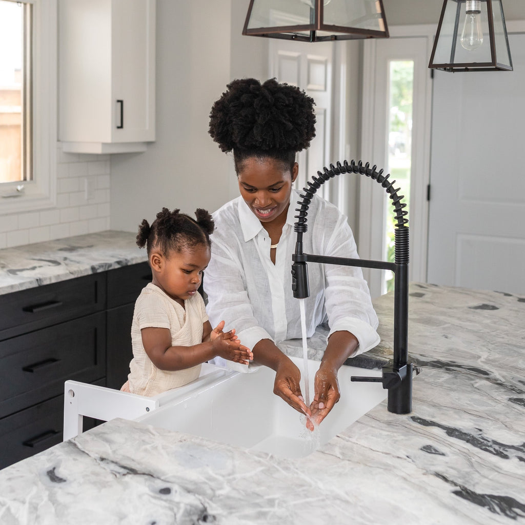 Child and Mother washing hands in sink with toddler standing on white Classic Montessori Learning Tower