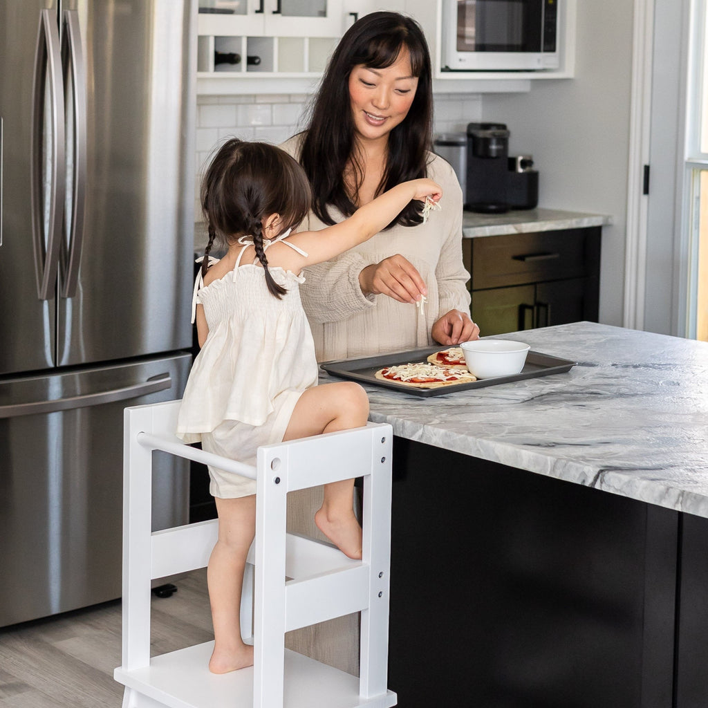 Child and Mother Making Pizza using Montessori Toddler Learning Tower Kitchen Helper.